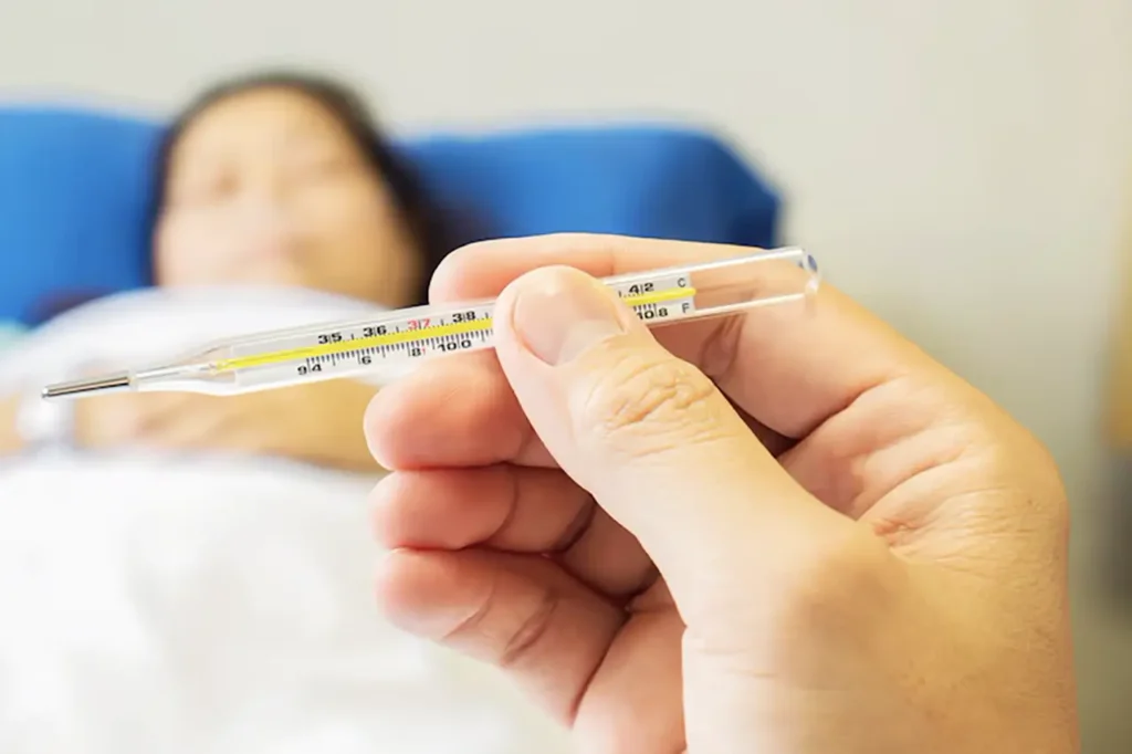 ডেঙ্গু প্রতিরোধে করণীয় 6 doctor is looking thermometer measuring body temperature his patient 1150 6142 copy 1