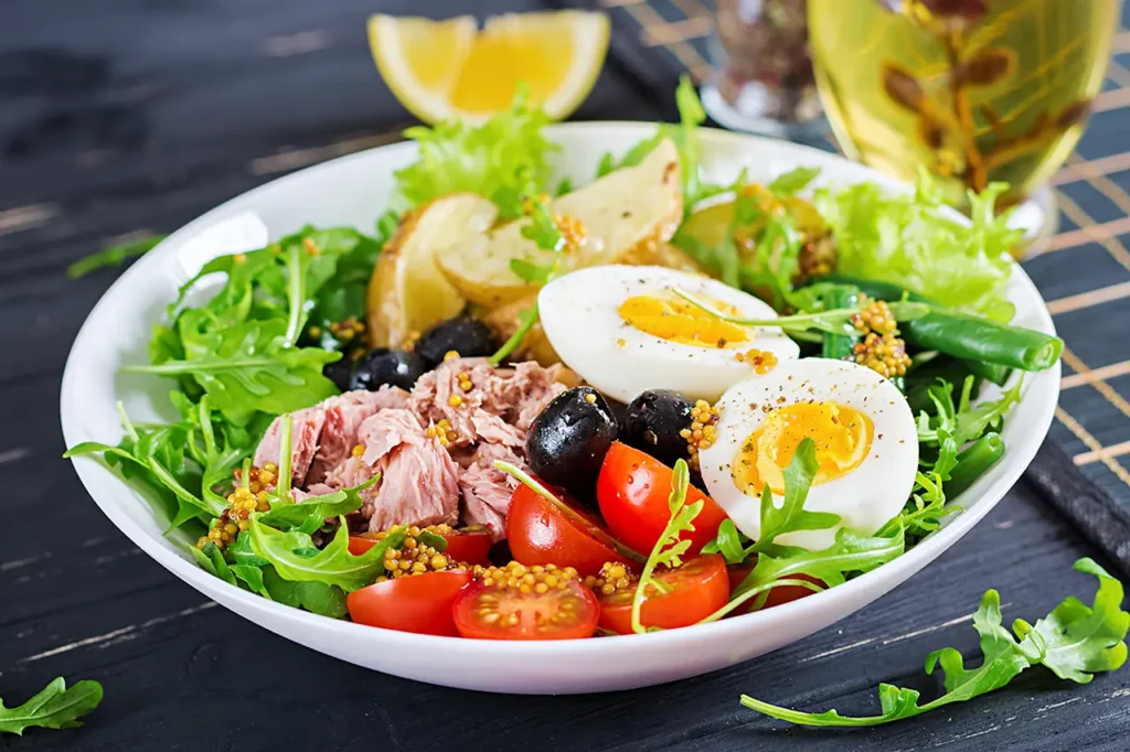 মেডিটারেনিয়ান ডায়েট যে কারণে শ্রেষ্ঠ 7 healthy hearty salad tuna green beans tomatoes eggs potatoes black olives close up bowl table